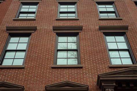 windows on a historic stone house porch with metal mullins|historical double hung windows.